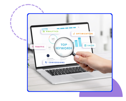 Hand holding a magnifying glass over a laptop screen highlighting top SEO metrics and analytics, representing *Advanced Keyword Strategy* — Brankdock.