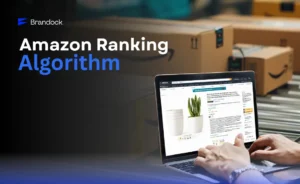 An informative e-commerce feature banner by Brandock explaining the Amazon Ranking Algorithm, showing a person optimizing a product listing on a laptop with Amazon shipping boxes in the background.