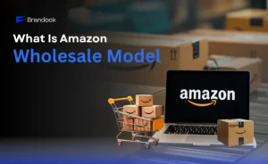 Educational graphic explaining what is Amazon Wholesale Model by Brandock, featuring a laptop with the Amazon logo, a mini shopping cart filled with shipping boxes, and warehouse packages in the background.