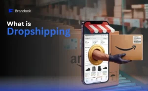 A smartphone screen displaying an Amazon Seller Central dashboard with a hand extending out to deliver a cardboard shipping box, illustrating What is Dropshipping by Brandock.